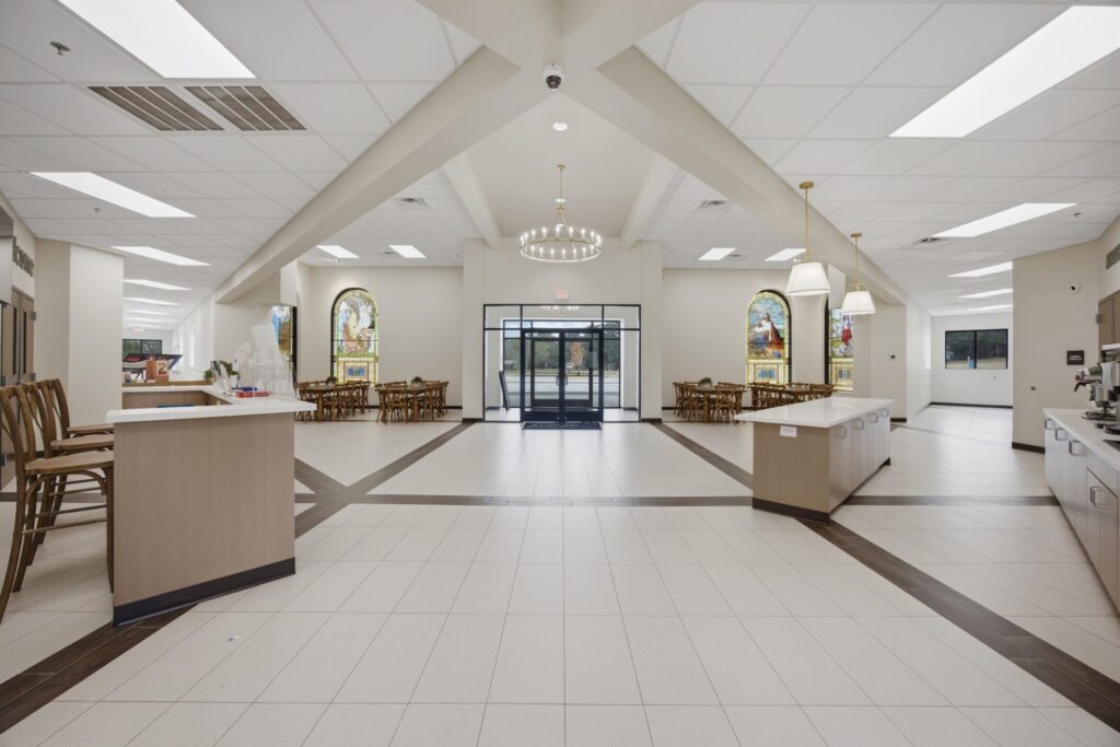 Open gathering area with seating and tile flooring
